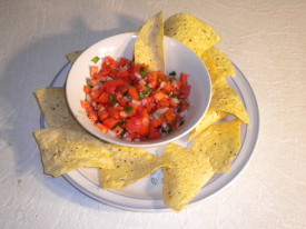 Here's the completed chunky salsa served with a plate of nacho chips as you'd eat them in a Mexican restaurant. Enjoy!